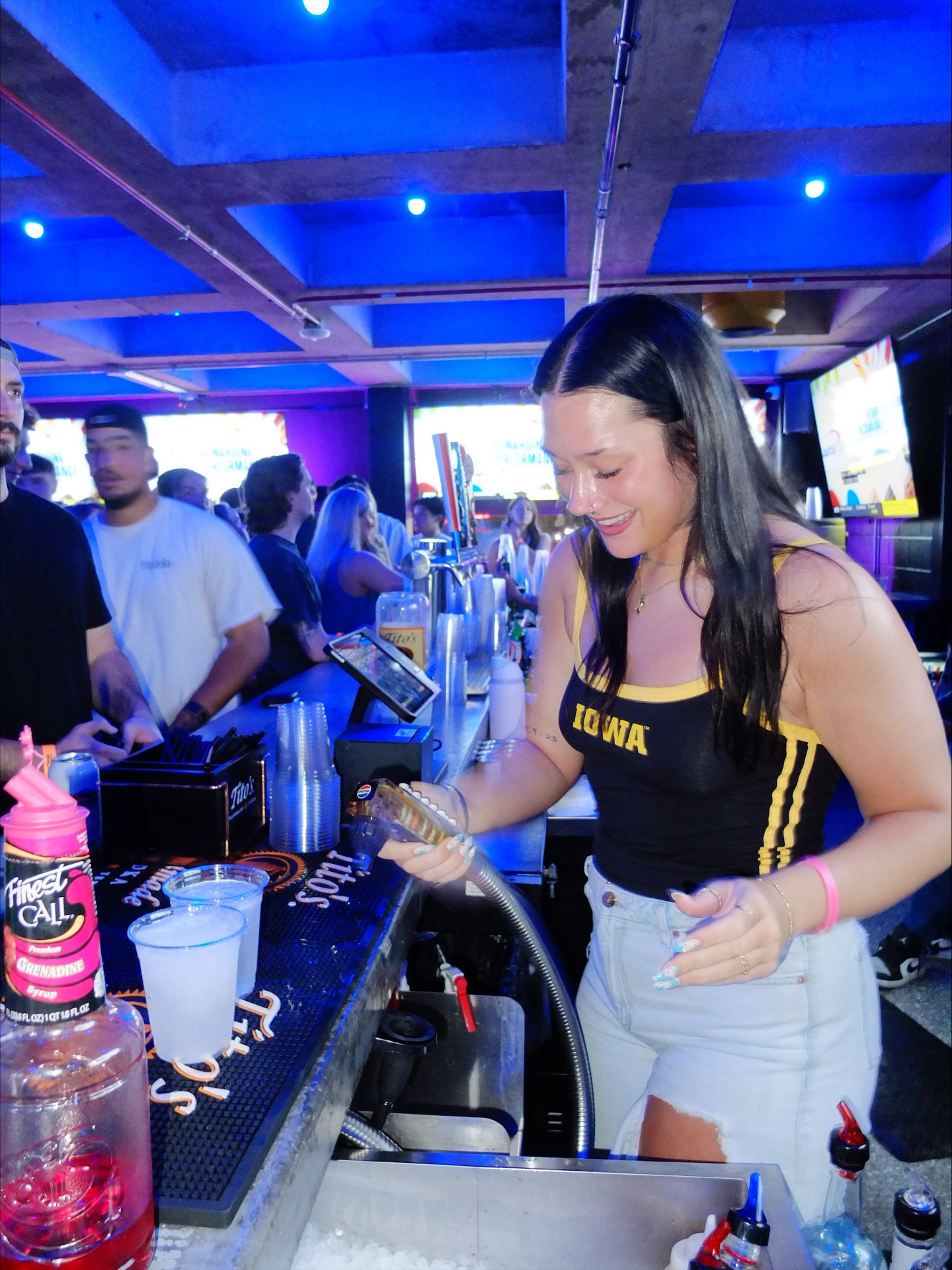 Bartender pouring drinks behind the bar at Fieldhouse
